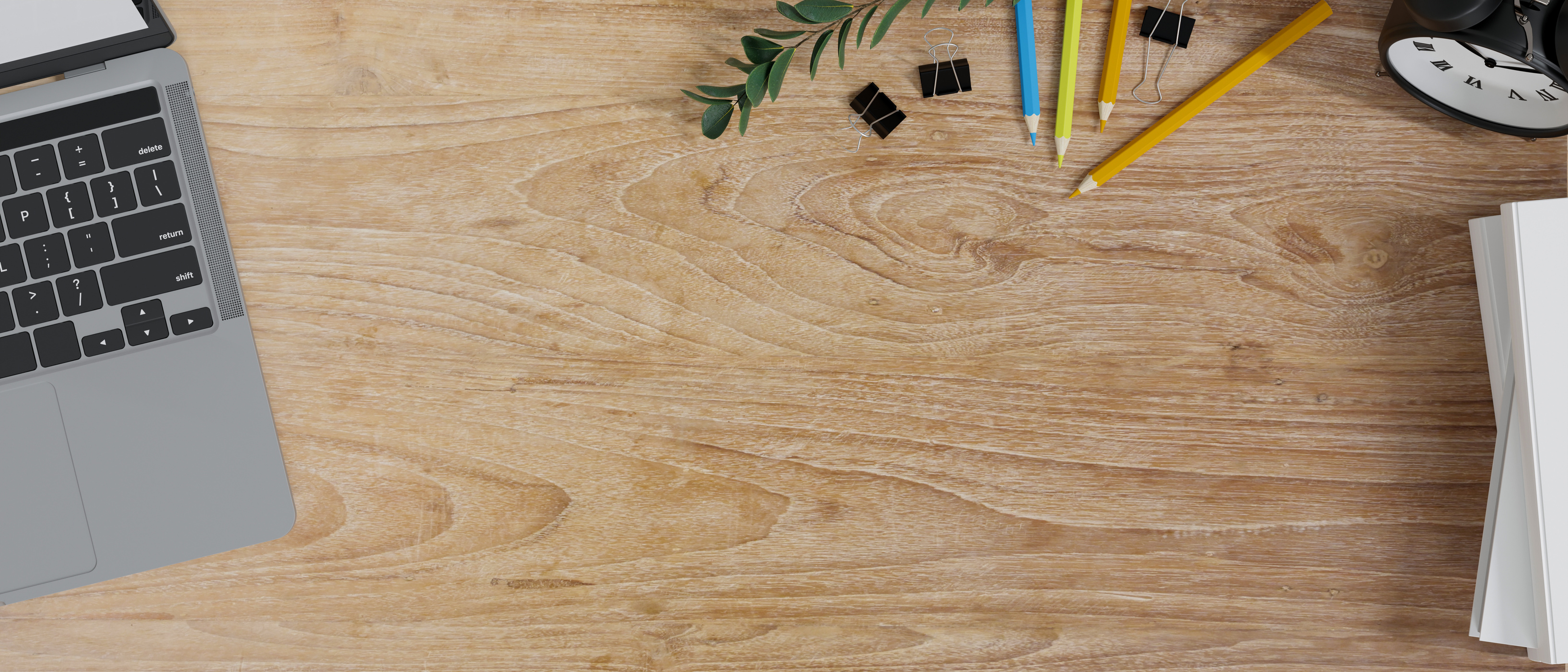 Copy space on wooden study table with laptop, stationery